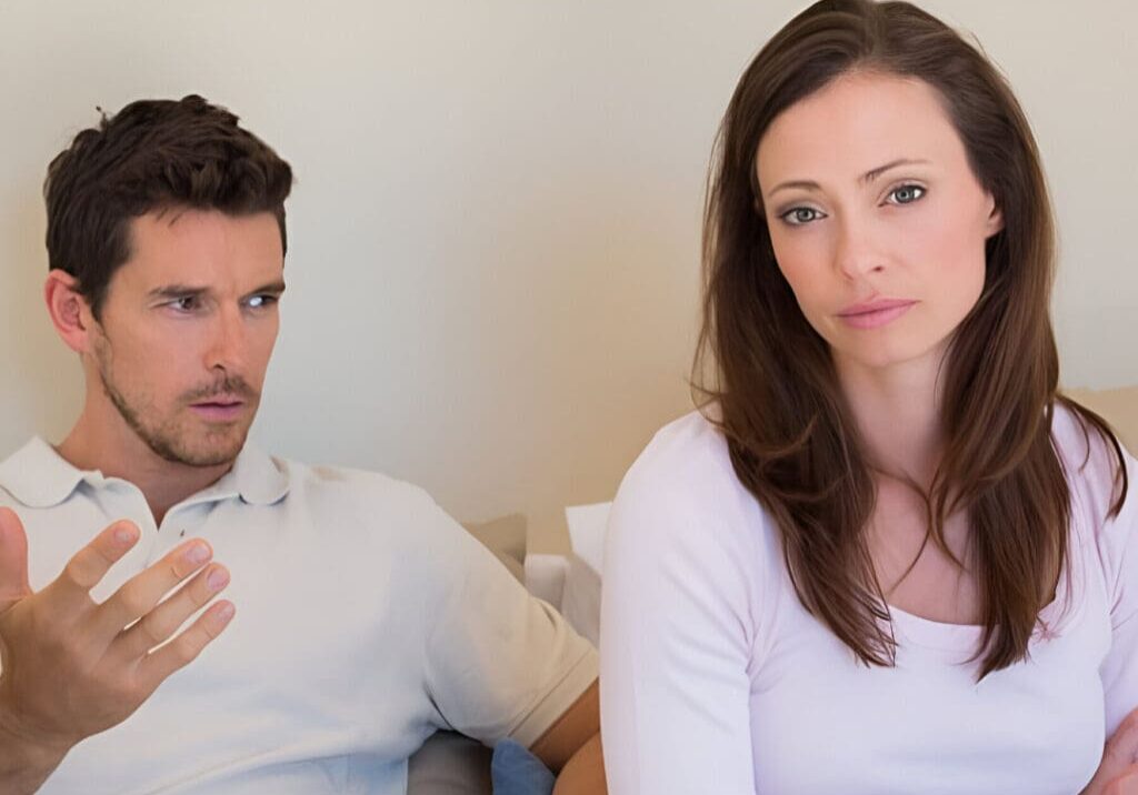 A man and woman sitting next to each other.