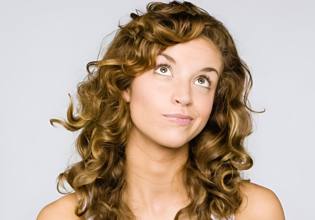 A woman with long hair is looking up.