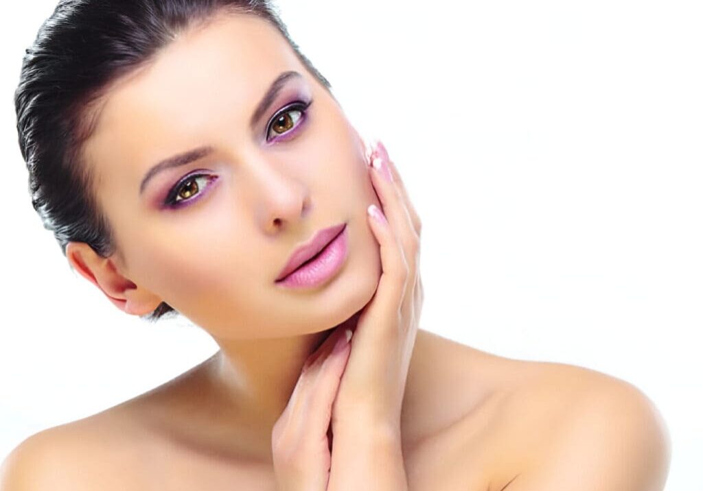 A woman with pink lipstick and bare shoulders.