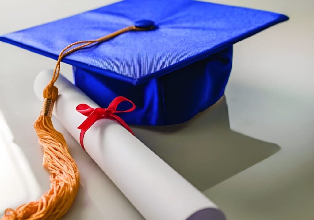 A blue cap and diploma on top of the table.