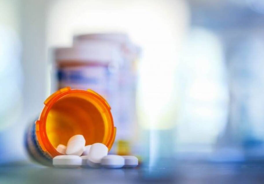 A close up of pills and a bottle