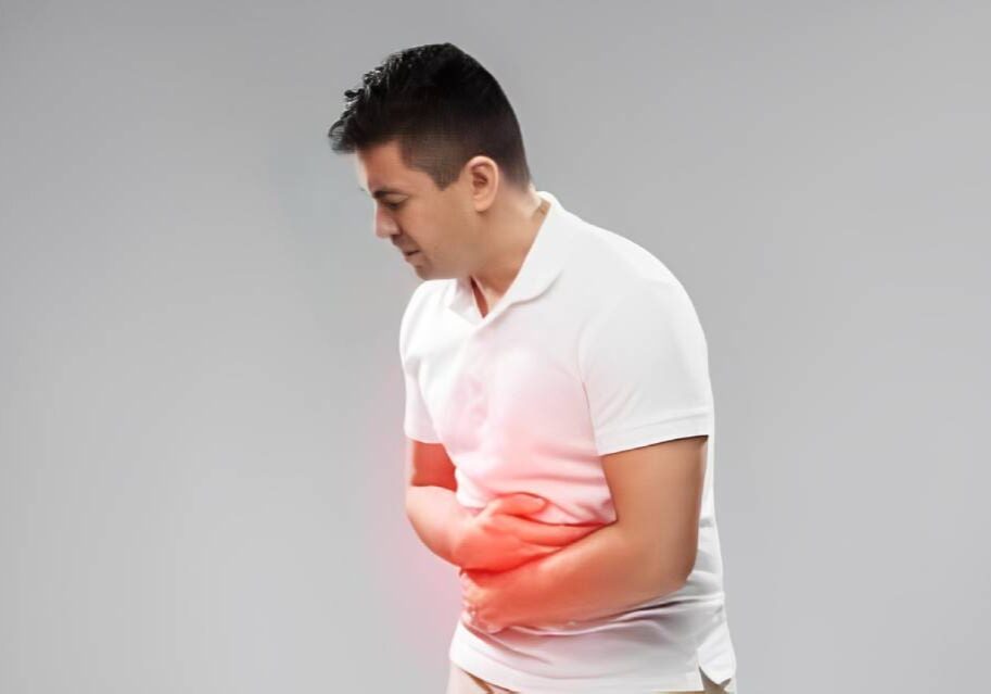 A man holding his stomach in pain.