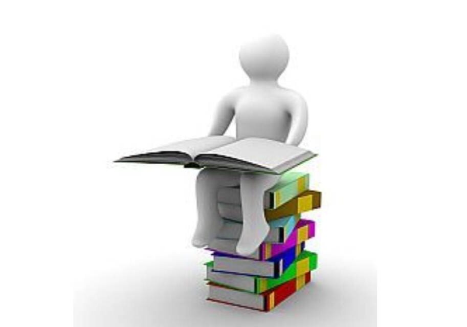 A person sitting on top of books with an open book.
