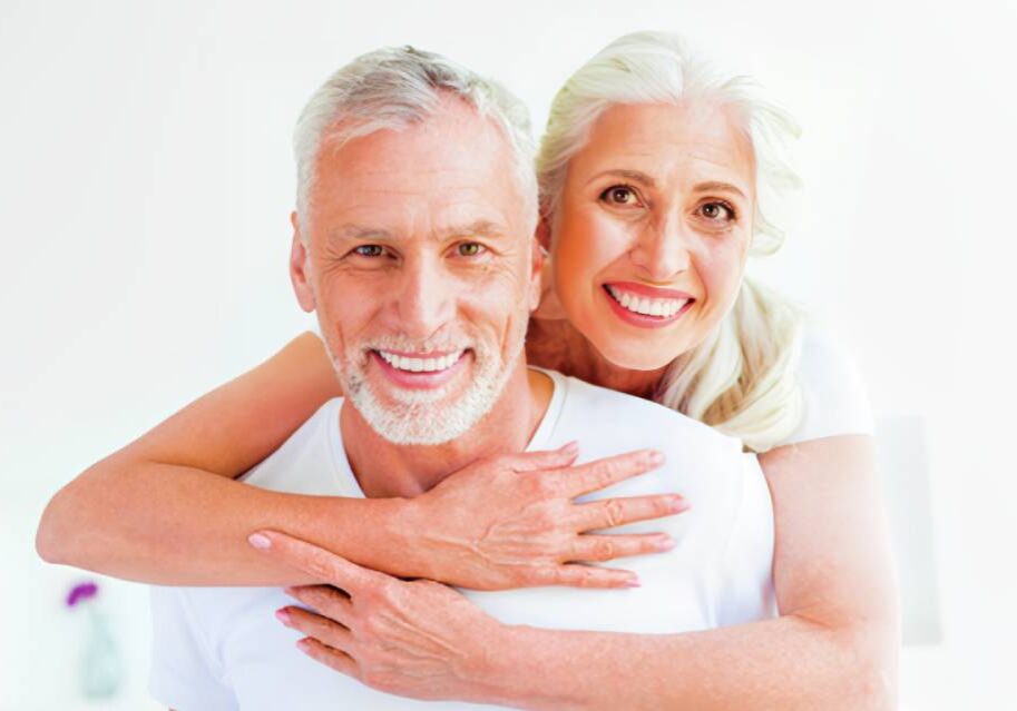 A man and woman are smiling for the camera.