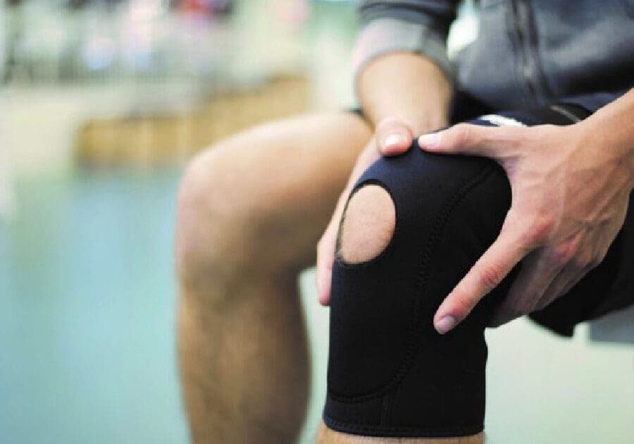 A person with knee braces on their legs