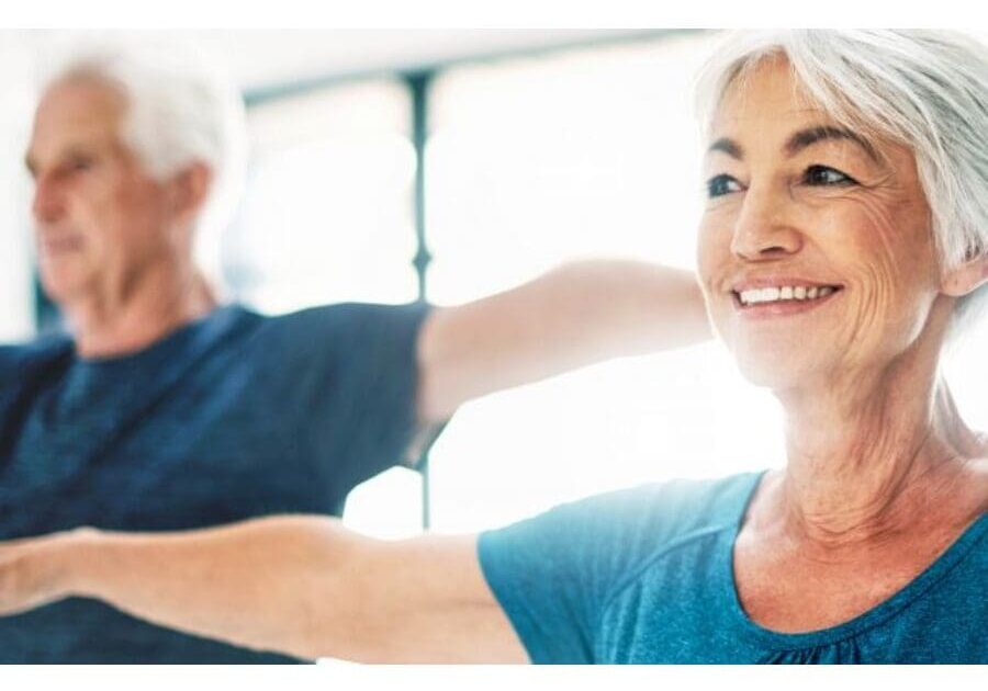 A woman and man are doing exercises together.