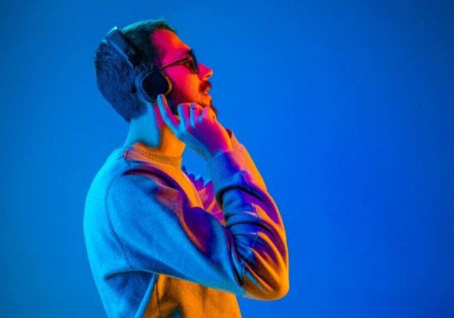 A man with headphones on talking on his cell phone.