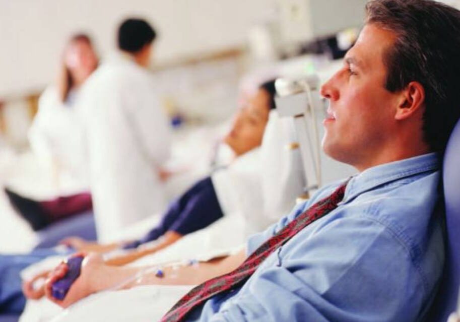 A man sitting in front of other people.