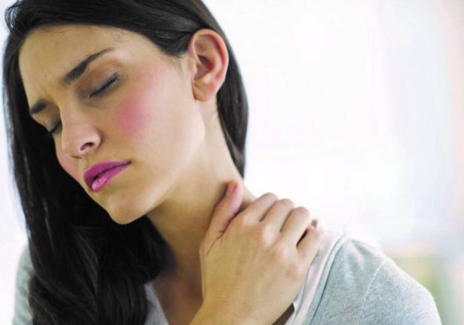 A woman with her hands on the neck of someone.