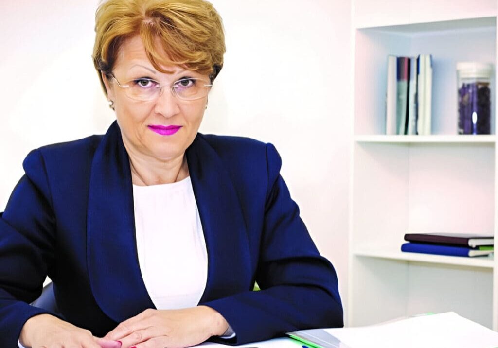 A woman sitting at her desk in front of a book.